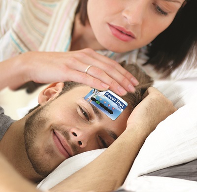 Concerned mother with hand on daughter's forehead